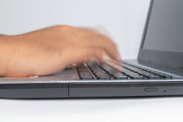 fast typing on keyborad motion blur of fast hand typing on laptop keyboard keyborad stock pictures, royalty-free photos & images