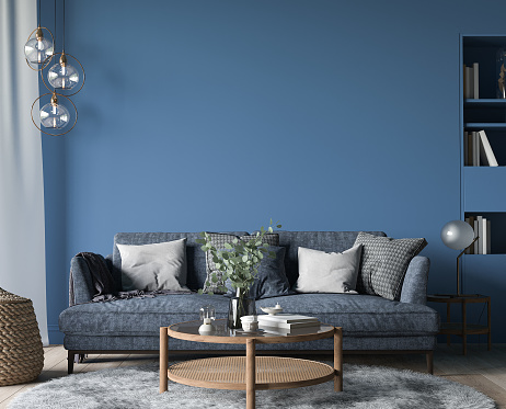 Dark living room interior, blue sofa with wooden home accessories in modern cozy apartment