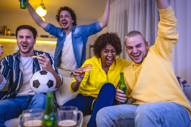 istock Friends watching Soccer game at home 1438564183