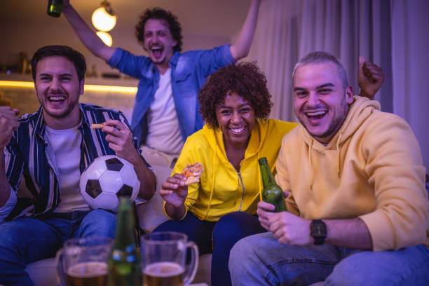 istock Friends watching Soccer game at home 1438566990