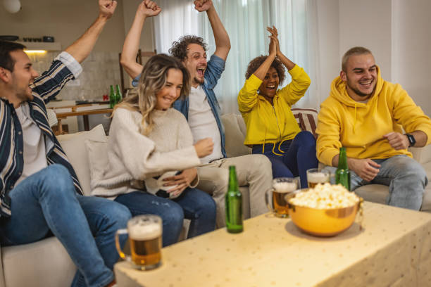 istock Soccer fans emotionally watching game at home. 1438567210