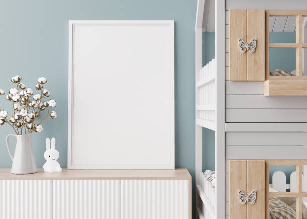 istock Empty vertical picture frame on the sideboard in modern child room. Mock up interior in contemporary, scandinavian style. Copy space for picture. Bed, cotton plant. Cozy room for kids. 3D render. 1438569542
