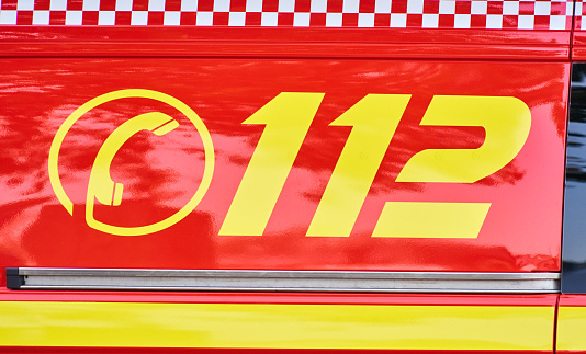 Close up view of German fire department emergency number 112 on fire truck to call for help in case of fire or accident