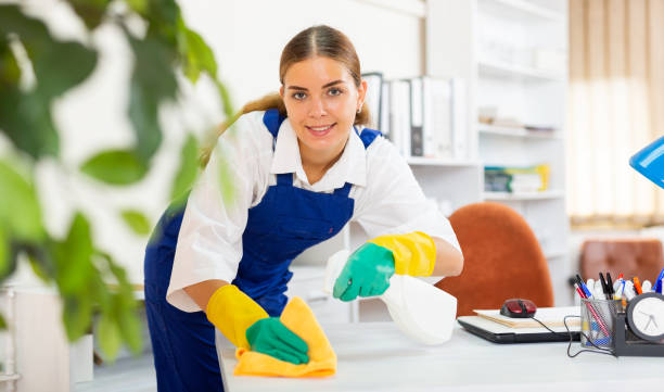 istock Young woman cleaning office 1438570807