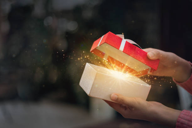 istock A hand is opening a wonderful gift box for his lover. 1438570923