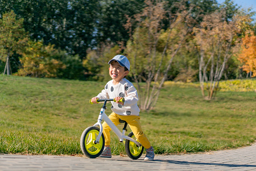 Baby practicing cycling in the park