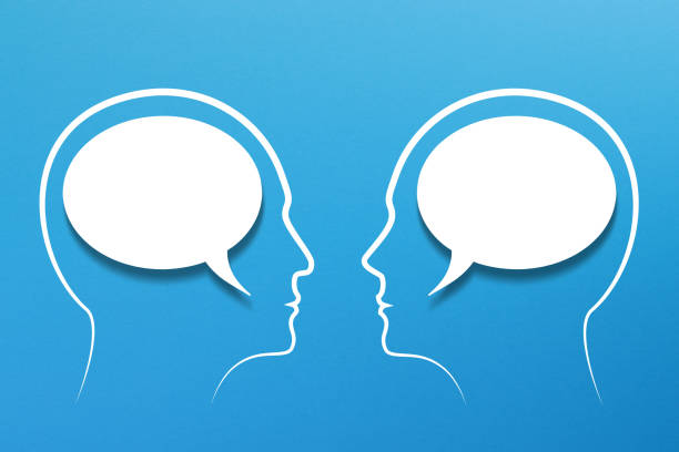 istock Blank speech bubbles inside man and woman heads 1438572786