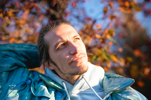 Portrait of a blue eyed young man, autumn colors
