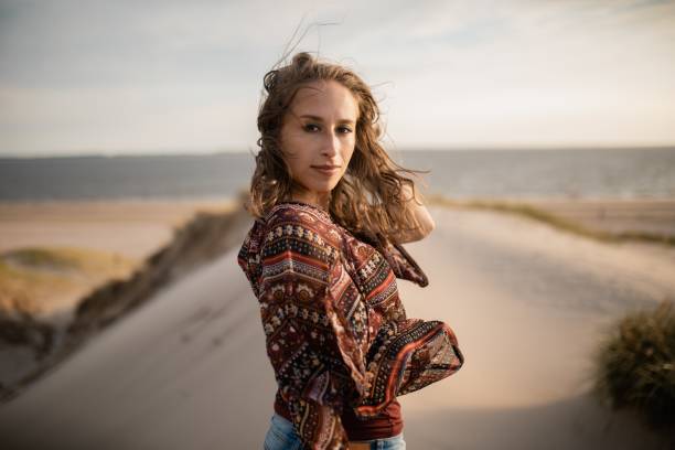 istock Woman playing with her hair during wind behind a blurred background 1438573113
