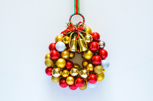 Colorful Christmas wreath made from baubles ornament on white background. Minimal holiday concept.