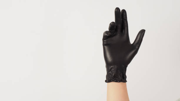 istock Hand is wear black latex gloves on white background. 1438573482