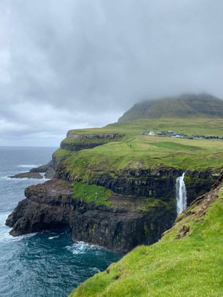 istock Vertical shot of a waterfall on a cliff in Faroe Islands 1438573622