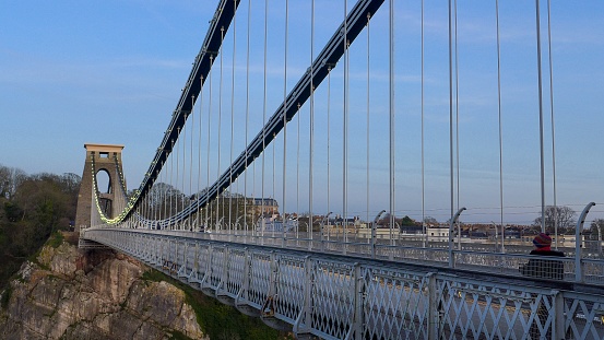 A vertical shot of Brunel suspension bridge in Bristol, the United Kingdom in the evening
