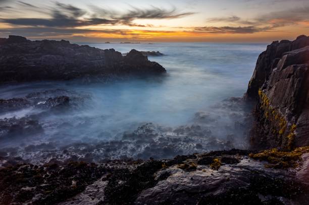 istock Beautiful view of a sea with rocky cliffs at sunset 1438574862