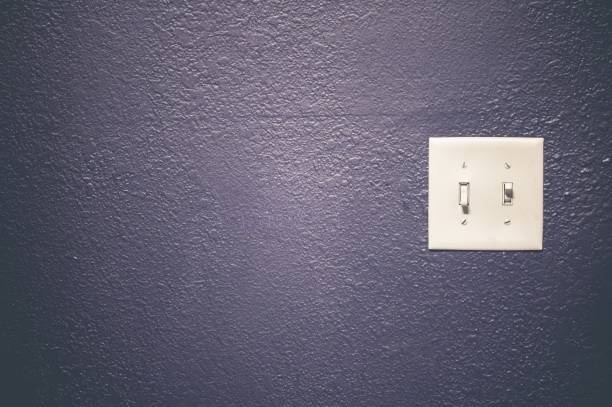 istock White light switch on a purple wall - great for a cool background 1438576166