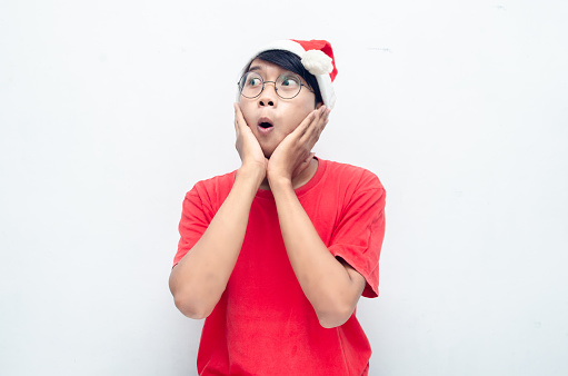 Shock Happy asian man in red santa hat