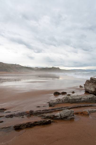 Vertical shot of The rocky Sopelana beach in Vizcaya, Spain on a rainy day A vertical shot of The rocky Sopelana beach in Vizcaya, Spain on a rainy day sopelana stock pictures, royalty-free photos & images
