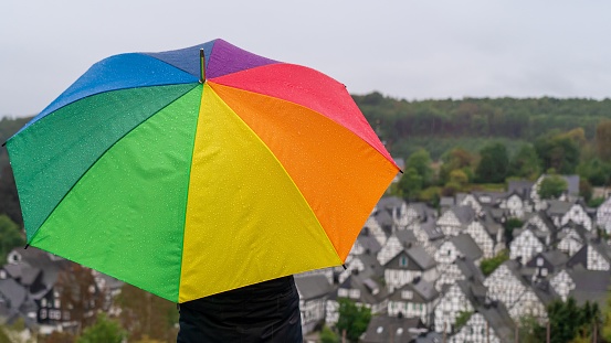 Girl holding a rainbow umbrella