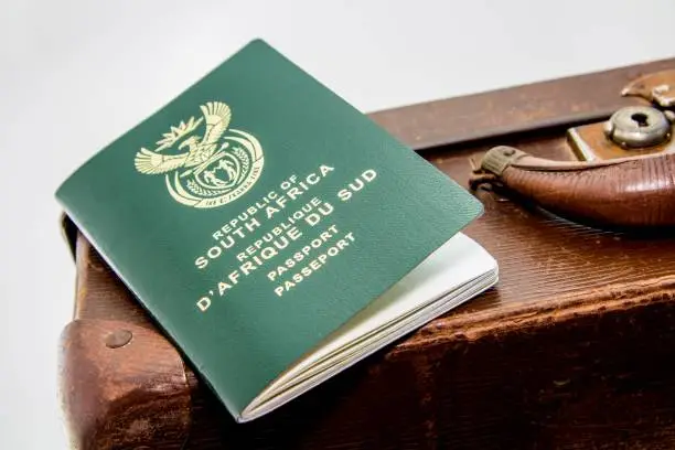 Photo of Closeup shot of a South African passport on a brown baggage