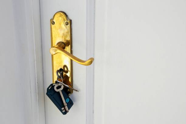 istock Golden doorknob with keys on a white door 1438580877
