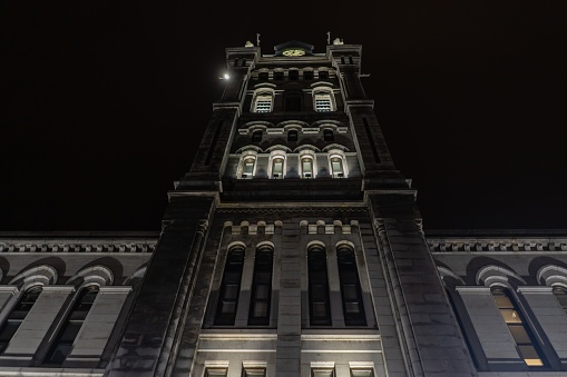 A low angle view of a building with the lights on during the night in Buffalo in New York