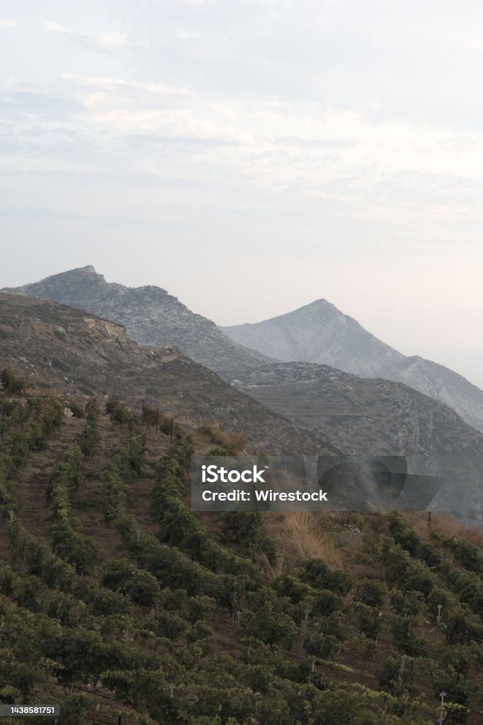 Vertical shot of a mountainous scenery touching the sky in the  Greek island of Sikinos A vertical shot of a mountainous scenery touching the sky in the  Greek island of Sikinos Architecture Stock Photo