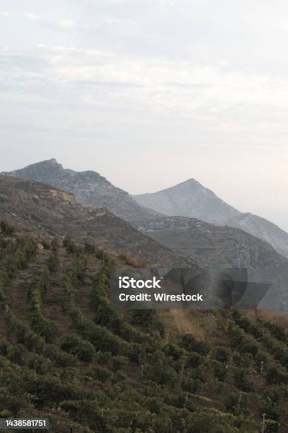 Vertical Shot Of A Mountainous Scenery Touching The Sky In The Greek Island Of Sikinos Stock Photo - Download Image Now