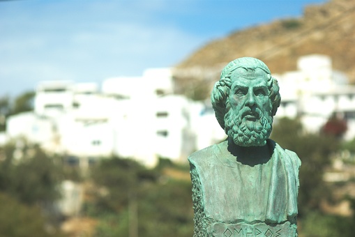 A selective focus shot of the bust of Homer in the Greek island of Ios