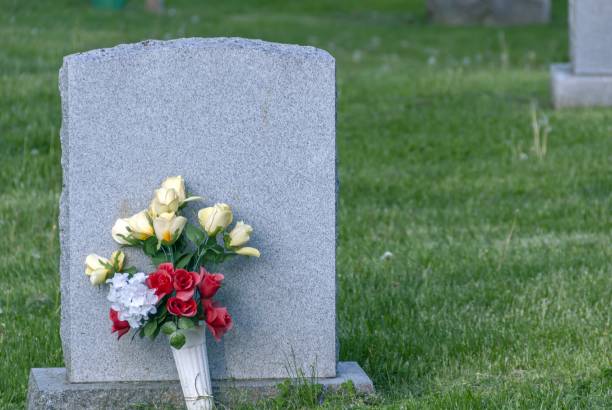 istock Put on a concrete grave surrounded by green grass 1438582046