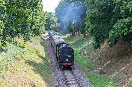 Horsted Keynes, United Kingdom – July 28, 2022: A high angle shot of a steam train on the Bluebell Railway in Horsted Keynes, UK