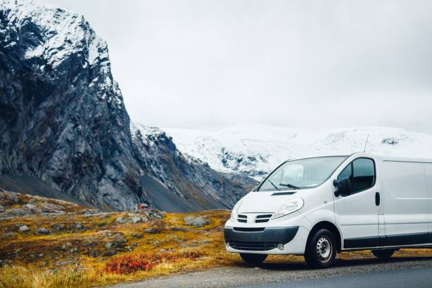 istock White van on the road surrounded by rocks covered in the snow 1438583445