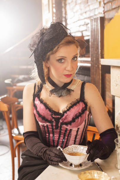 istock Retro Old-fashioned young woman at Party, drinking tea. 1438585318