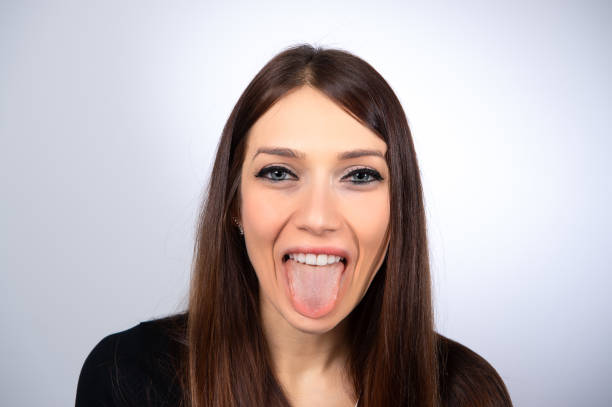 istock smiling girl showing her tongue 1438586418