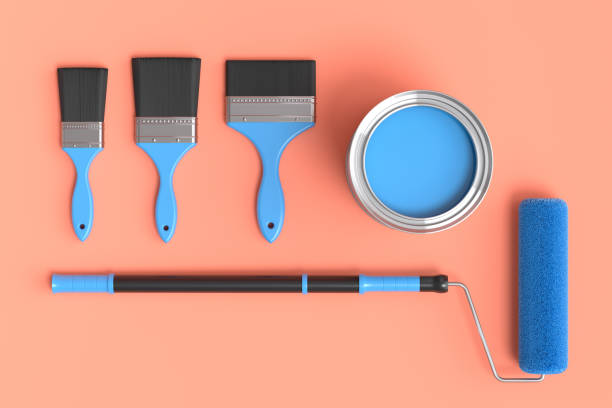 istock Set of metal cans or buckets with paint rollers and brushes on orange background 1438586511