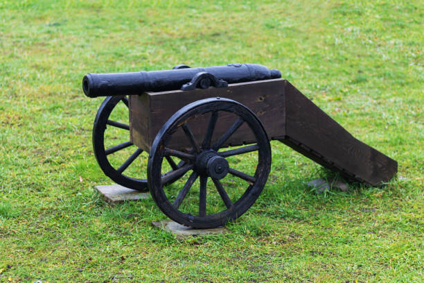 istock Civil war cannon on green grass battlefield 1438586626