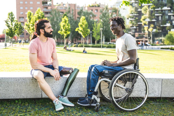 istock Two friends with disability having break time in a city park 1438587929