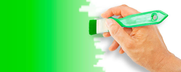 Greenwashing concept with hand which paints in green - concept image with copy space stock photo
