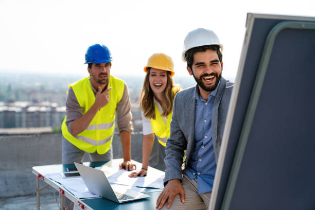 istock Diverse team of specialists with computer on construction site. Building project with engineers 1438588047