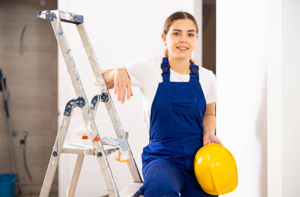 istock Smiling woman repairer standing inside apartment 1438588507