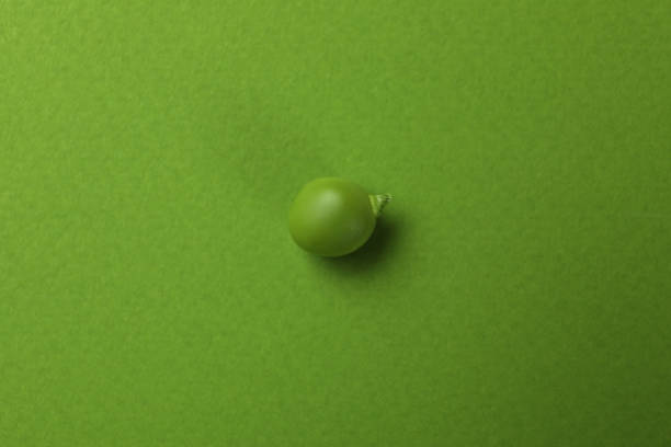 Green pea seed on green background, close up
