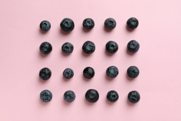istock Fresh berry concept with blueberry on pink background 1438589777