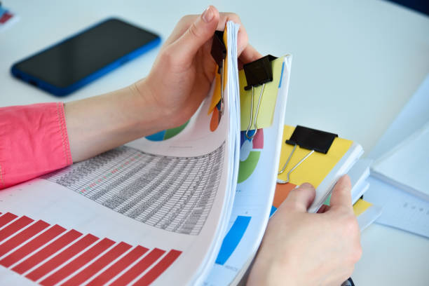 istock Accountant woman searching in stack of documents 1438590214