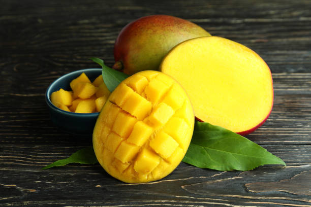 istock Tasty ripe mango fruit on wooden table 1438591216