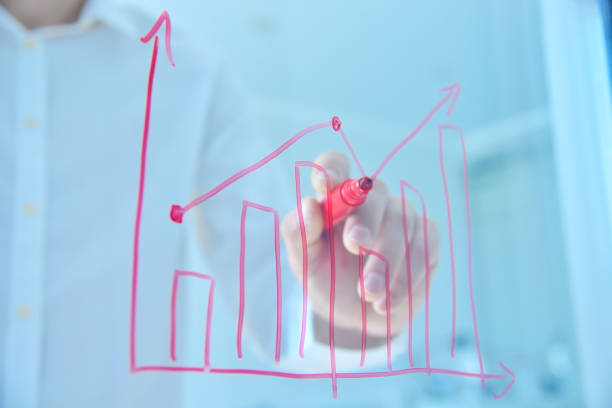 istock Businessman drawing trade markets on transparent screen. 1438591607