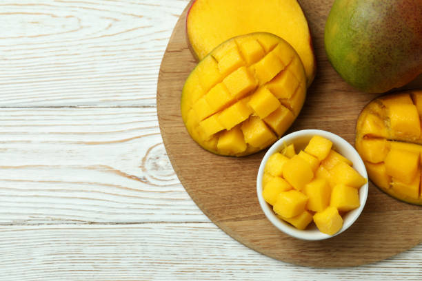 istock Tasty ripe mango fruit on wooden table 1438591744