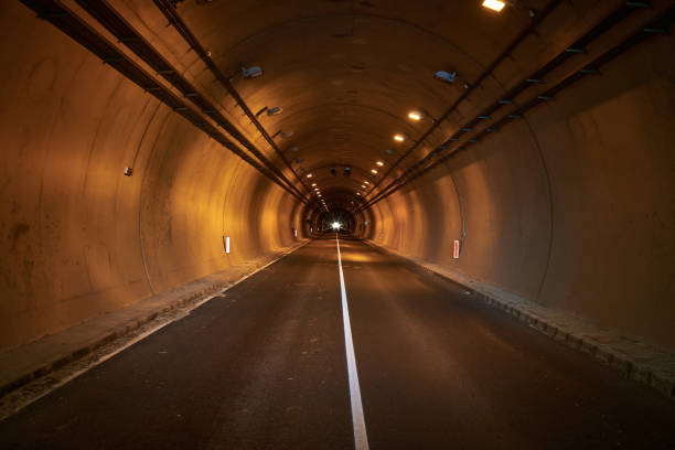 istock empty car road in illuminated tunnel 1438592052