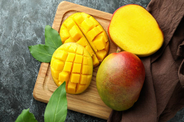 istock Tasty ripe mango fruit on black smokey table 1438592250