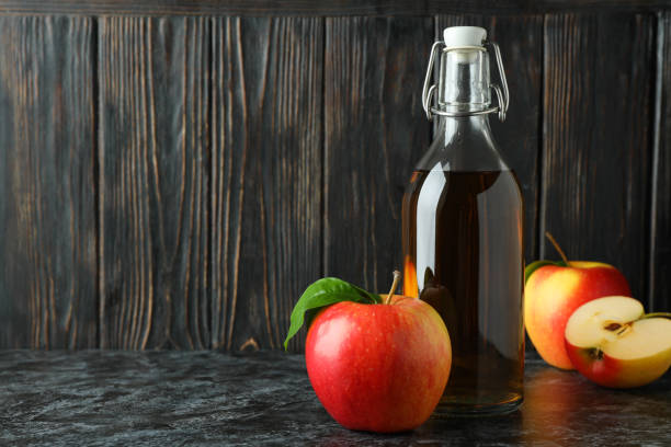 istock Homemade apple vinegar and ingredients on black smokey table 1438593399