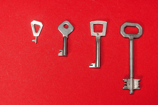 Closeup  on an old keys on a red background.