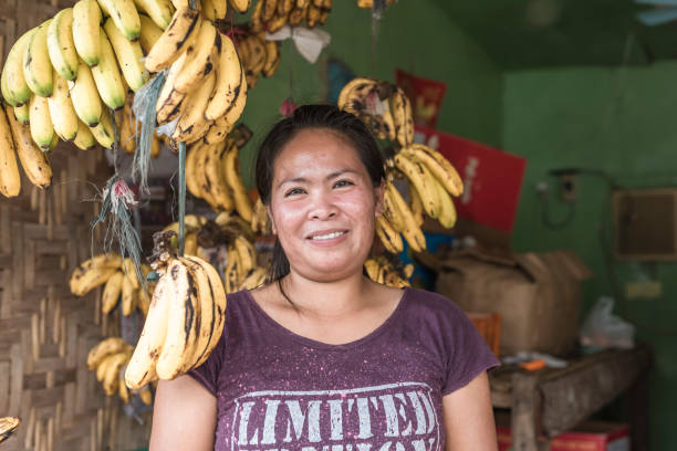 Sagbayan, Bohol, Philippines - May 2022: A local vendor posing with her fruits inside her store.